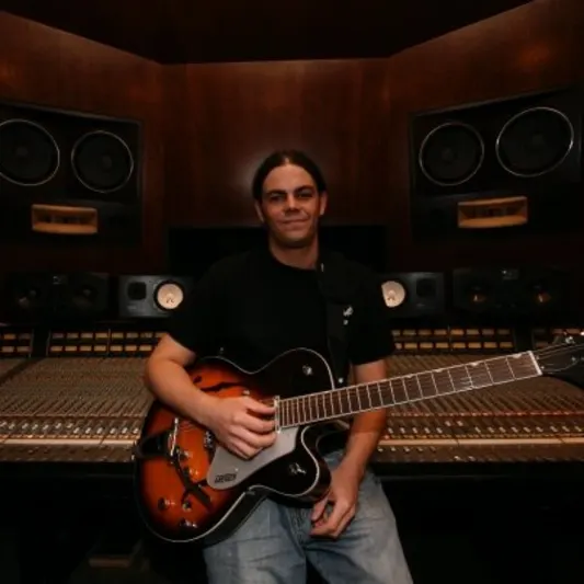 Daniel Groover with a hollow-body guitar at the SSL console in ZAC Recording, Atlanta